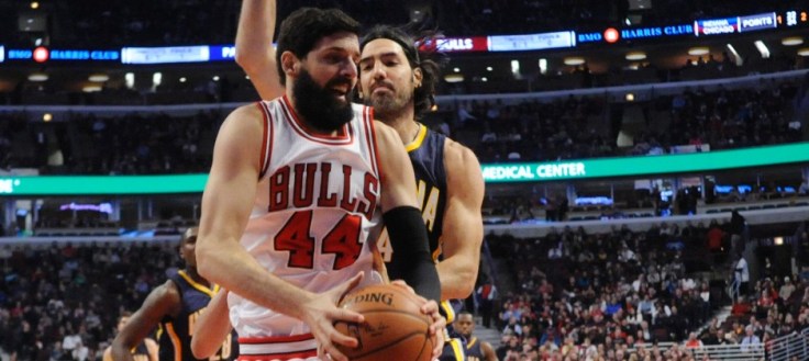 Mar 18, 2015; Chicago, IL, USA; Chicago Bulls forward Nikola Mirotic (44) grabs a rebound in front of Indiana Pacers forward Luis Scola (4) during the first half at the United Center. Mandatory Credit: David Banks-USA TODAY Sports